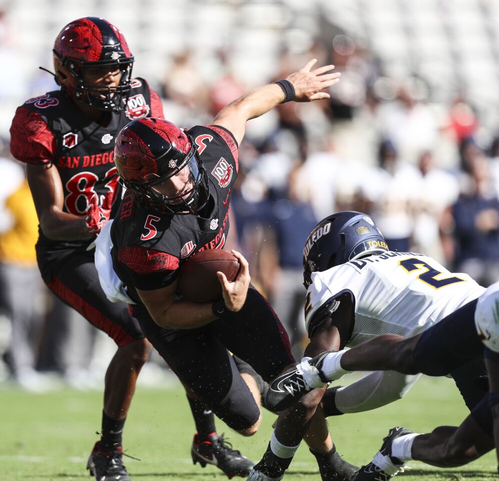 San Diego State's quarterback Braxton Burmeister (5) is taken down by Toledo's linebacker Dyontae Johnson (2) during their game at Snapdragon Stadium on Saturday, Sept. 24, 2022 in San Diego, CA.