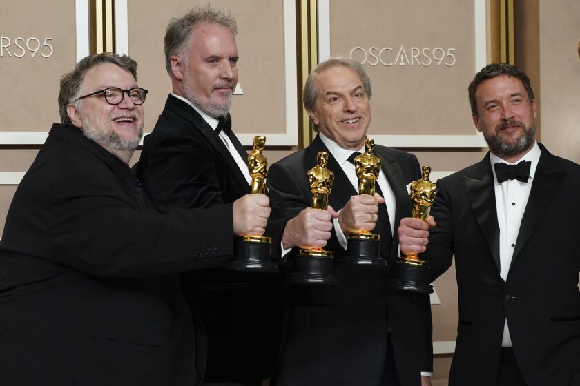 Guillermo de Toro, from left, Mark Gustafson, Gary Ungar, and Alex Bulkley, winners of the award for best animated feature film for "Guillermo del Toro's Pinocchio," pose in the press room at the Oscars on Sunday, March 12, 2023, at the Dolby Theatre in Los Angeles. (Photo by Jordan Strauss/Invision/AP)