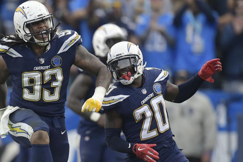 Los Angeles Chargers defensive tackle Darius Philon (93) celebrates his sack of Cincinnati Bengals quarterback Jeff Driskel, next to teammate Desmond King (20) on a two-point conversion attempt late in the fourth quarter during an NFL football game Sunday, Dec. 9, 2018, in Carson, Calif. (AP Photo/Mark J. Terrill)