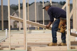 FILE - In this March 16, 2021 file photo, a carpenter aligns a beam for a wall frame at a new house site in Madison County, Miss. U.S. construction spending rose a modest 0.2% gain in April as strength in housing offset further weakness in nonresidential construction. (AP Photo/Rogelio V. Solis, File)