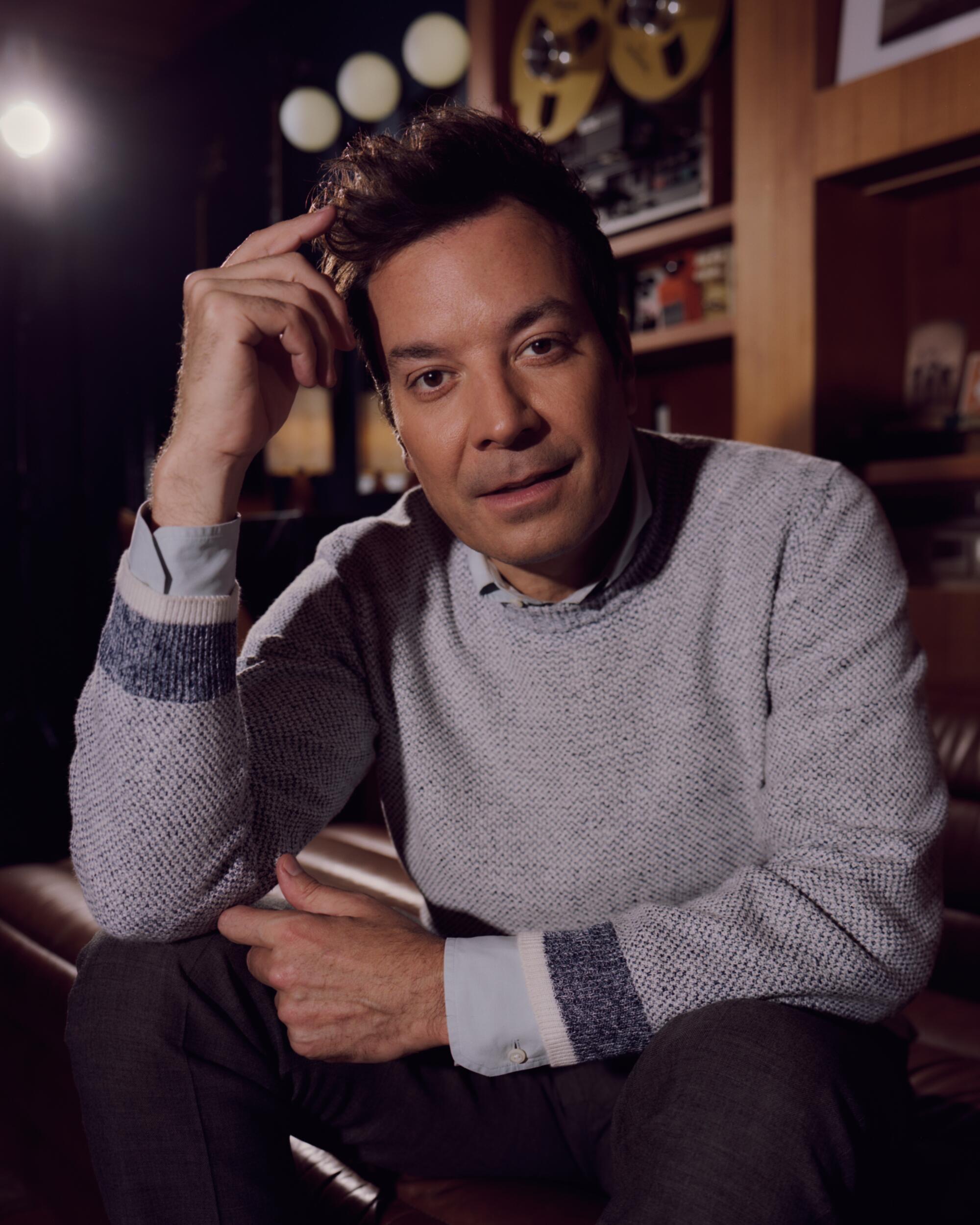 Jimmy Fallon rests his head on his hand for portrait.