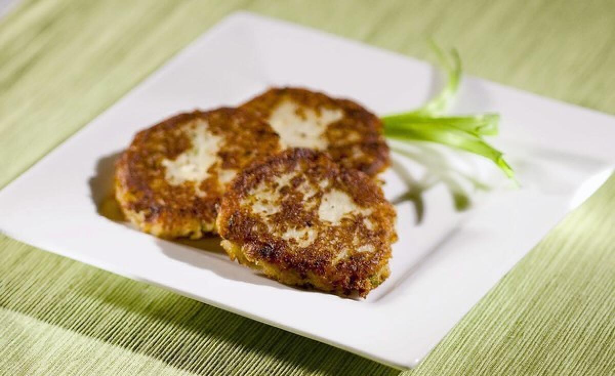 Potato latkes are made with feta cheese and two types of onion. The potatoes can be steamed first in the microwave.