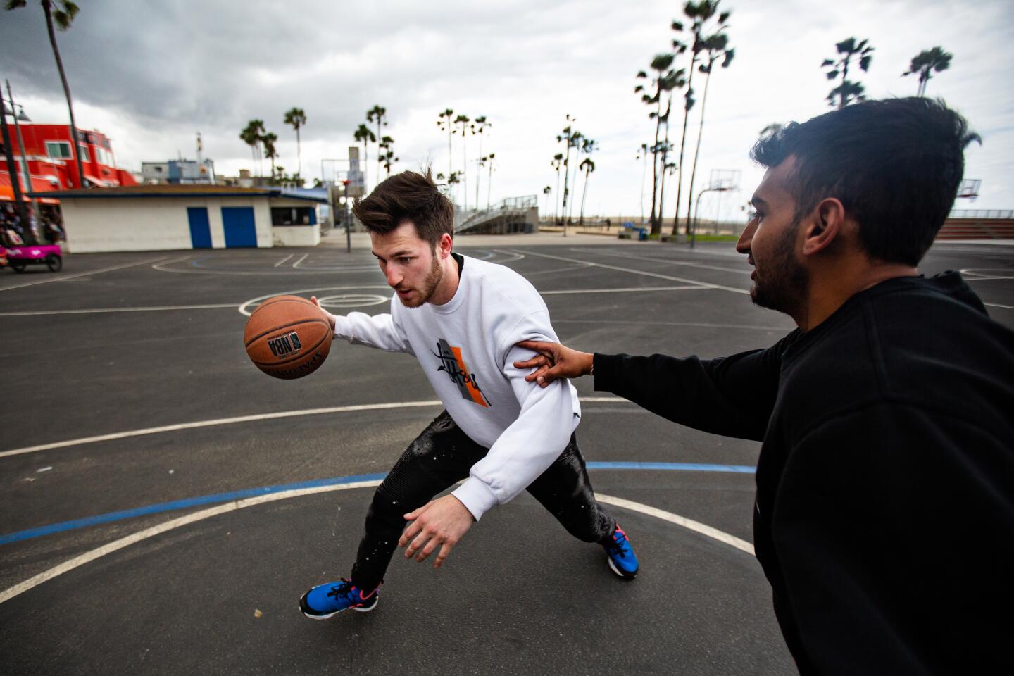 While on vacation Devon Zubka, 22 of Las Vegas and Dhruv Patel, 22, of Louisville play basketball at Venice Beach on Monday in Venice.