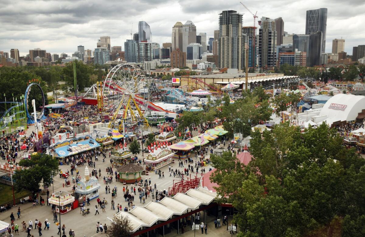 Downtown's skyscrapers rise beyond the grounds where the Calvary Stampede is held.