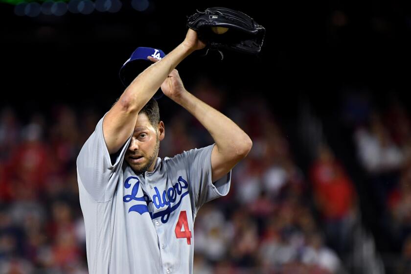 WASHINGTON D.C., OCTOBER 7, 2019-Dodgers pitcher Rich Hill wipes his face after giving up a hit to the Nationals in the 2nd inning in Game 4 of the NLDS at Nationals Stadium Monday. (Wally Skalij/Los Angeles Times)