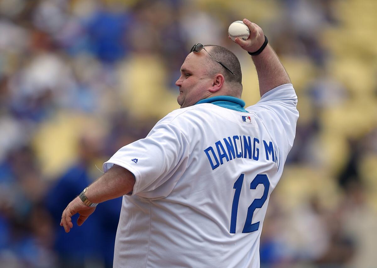 Sean O'Brien of Liverpool, England, known on the Internet as "Dancing Man," throws out the ceremonial first pitch for Sunday's game between the Dodgers and the San Diego Padres at Dodger Stadium.
