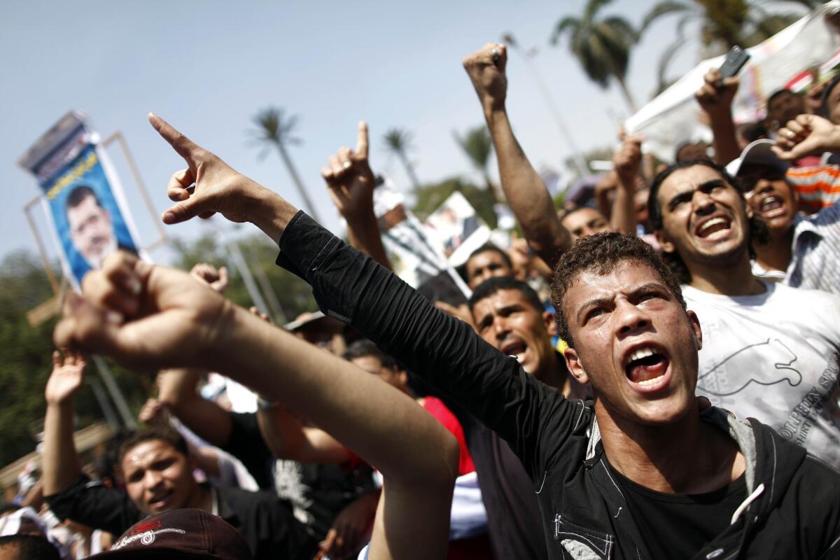 Supporters of the Muslim Brotherhood and ousted President Mohamed Morsi shout religious and political slogans during a protest near Cairo University in the Egyptian capital on Friday.