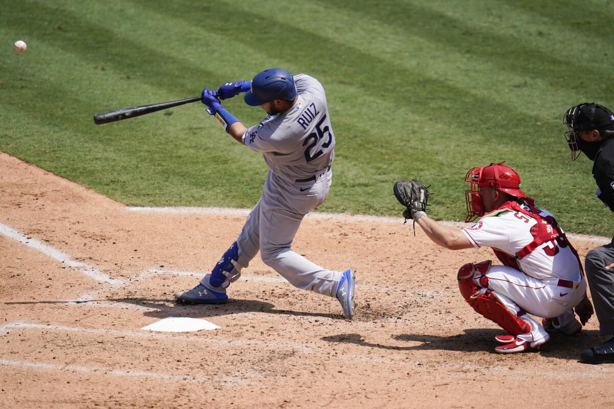 Los Angeles Dodgers Keibert Ruiz hits a solo home run during the third inning of a baseball game.