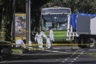 Experts work at a crime scene in Mexico City