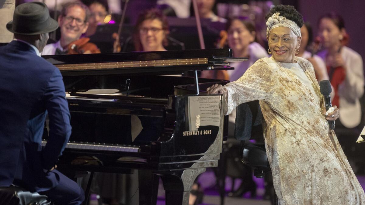 Cuban singer Omara Portuondo beams at her frequent accompanist, pianist Roberto Fonseca, during their performance Tuesday with the L.A. Philharmonic at the Hollywood Bowl