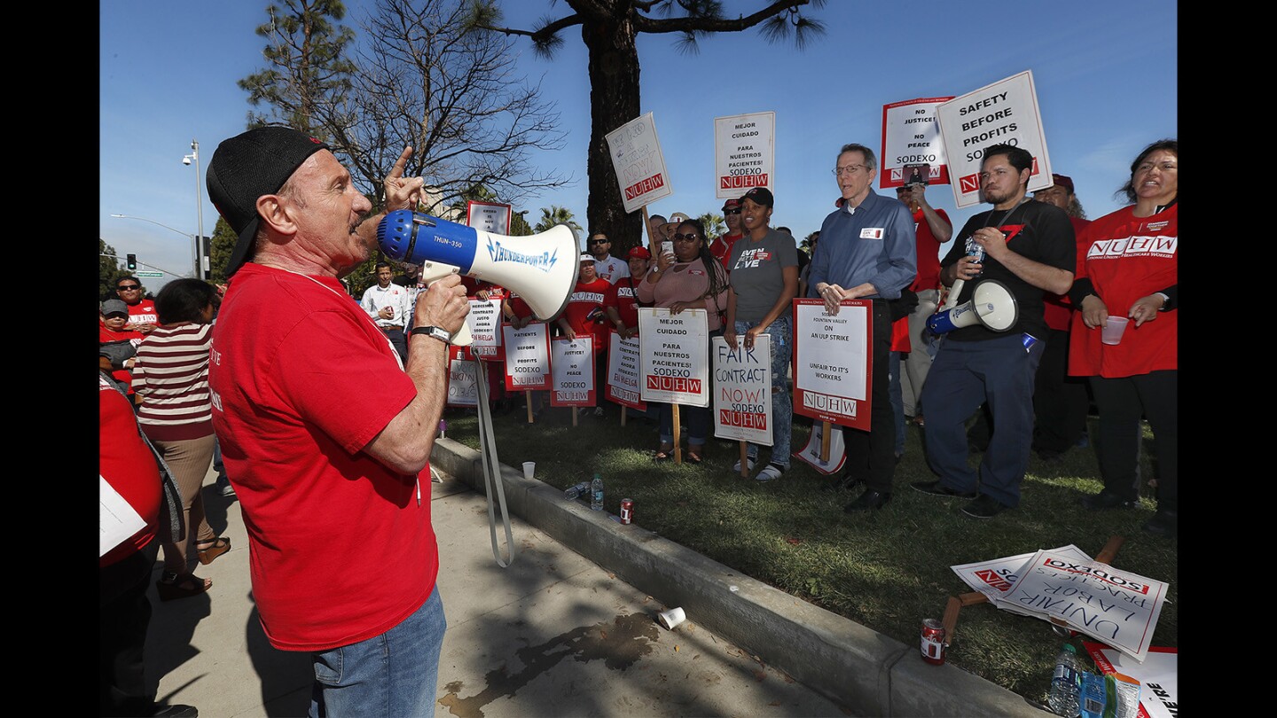 Sal Rosselli, National Union of Healthcare Workers president, speaks to union members and supporters during a strike at Fountain Valley Regional Hospital & Medical Center on Thursday. The protest included more than 100 housekeeping and food service staff members who work for contractor Sodexo.