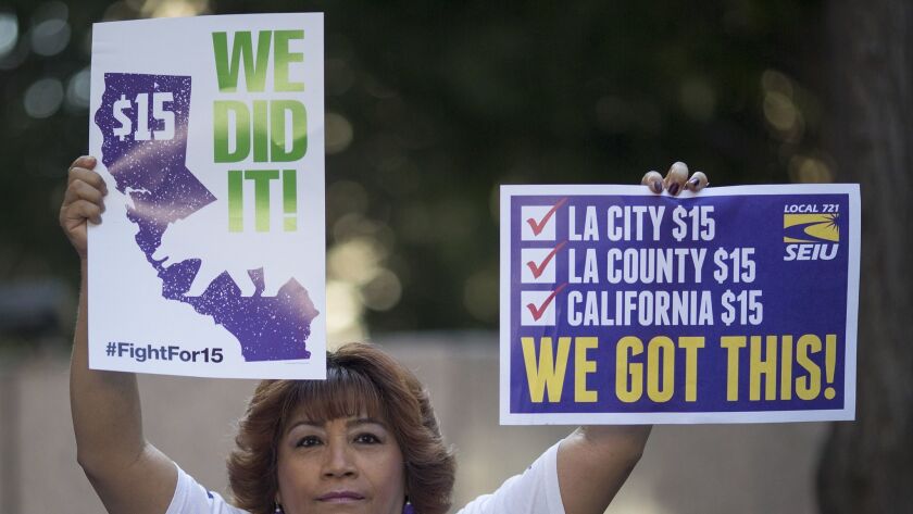 A Service Employees International Union member celebrates after Gov. Jerry Brown signed legislation on April 4, 2016, making California the first state to commit to raising the minimum wage to $15 per hour.