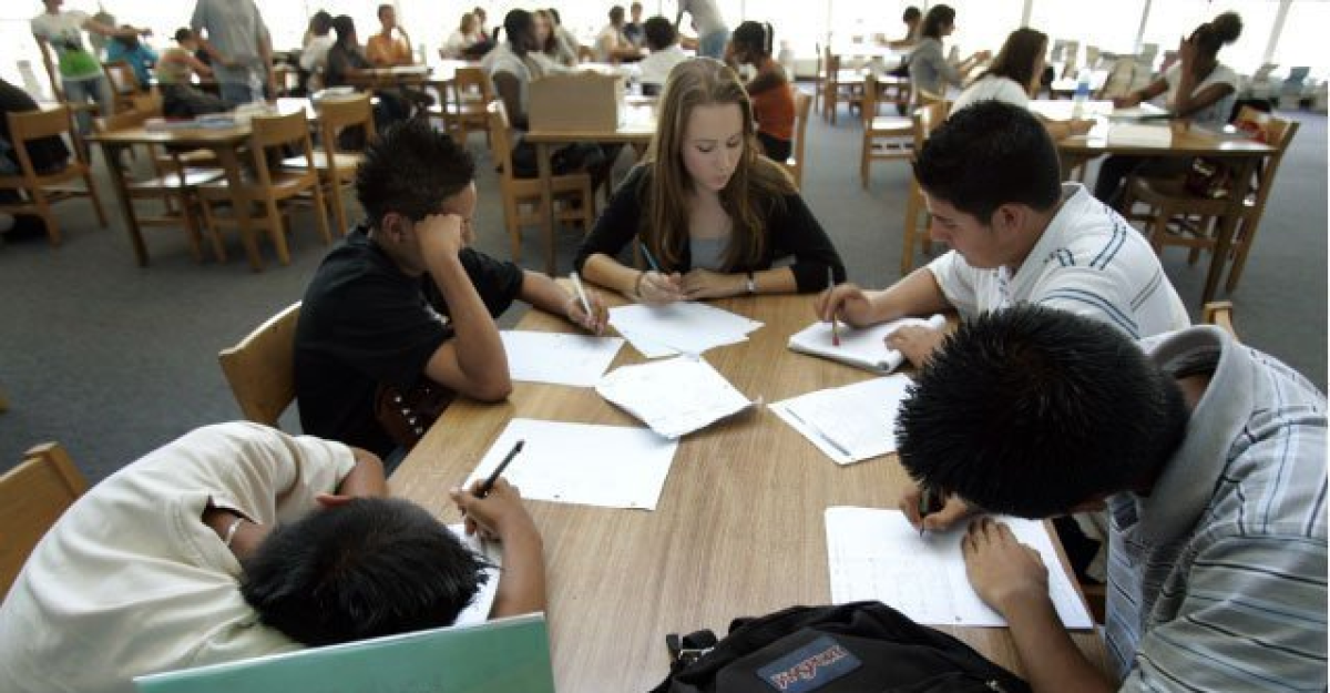 Five students study at a table in a Scripps Ranch High tutoring program in 2016