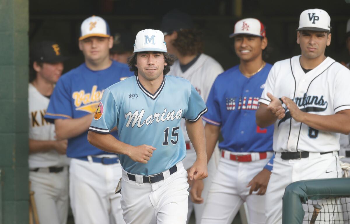 North All-Star Gavin Langer (15) of Marina High runs up to receive a pre-game certificate on Tuesday.