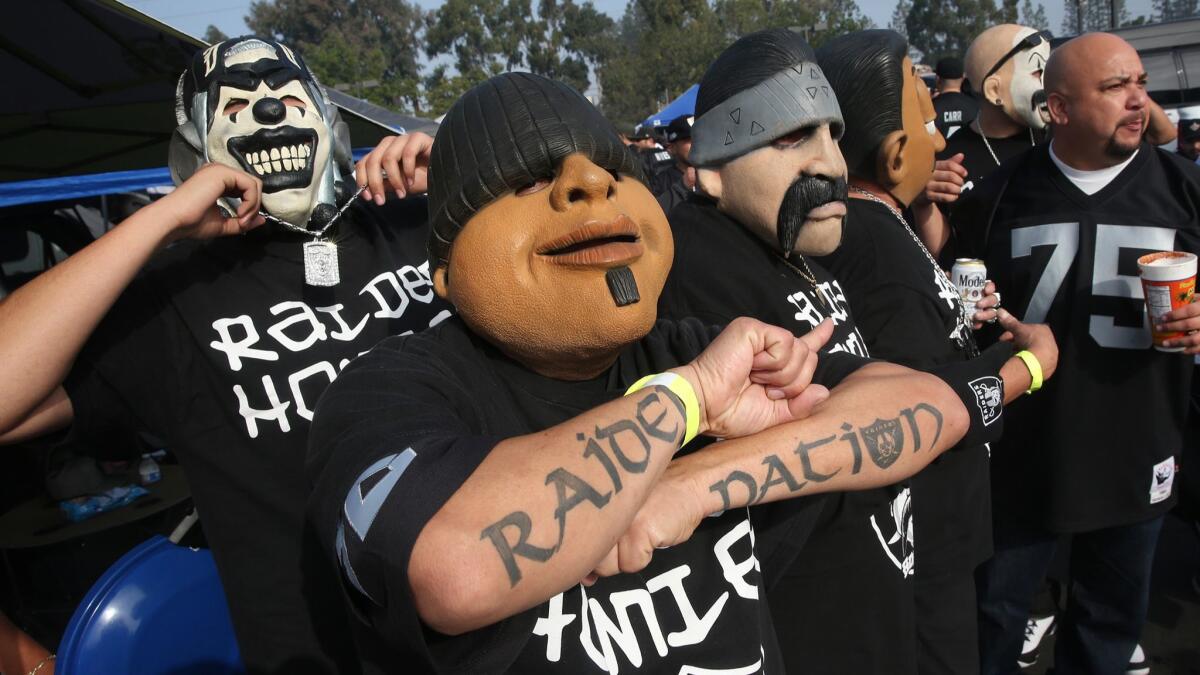 Gonzalo Gonzalez flashes a "Raider Nation" tattoo as he and others promoting Homies toys parade around the tailgating lot at Stubhub Center.