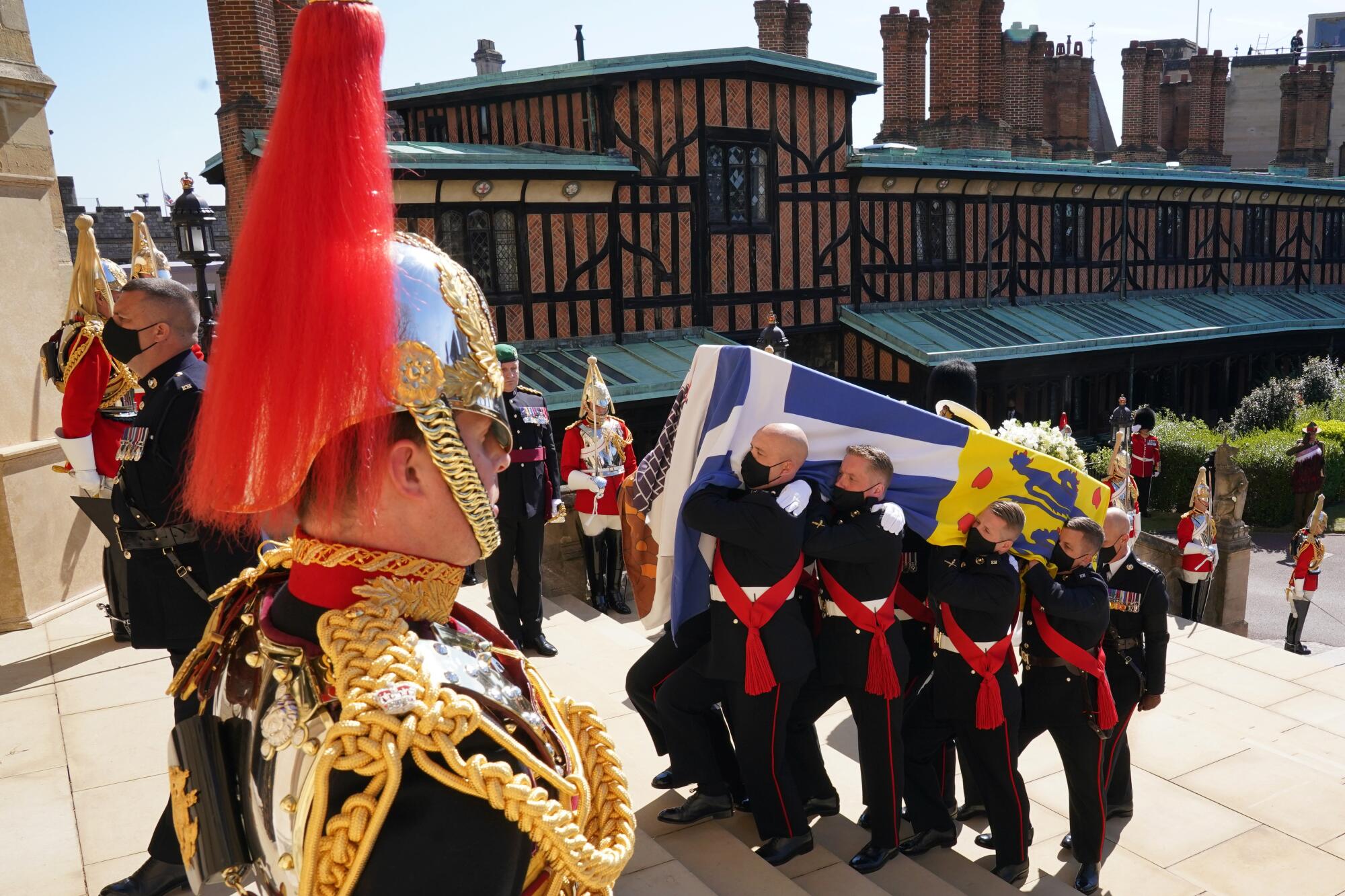 The coffin of Prince Philip is carried up the steps of St. George's Chapel by pallbearers 