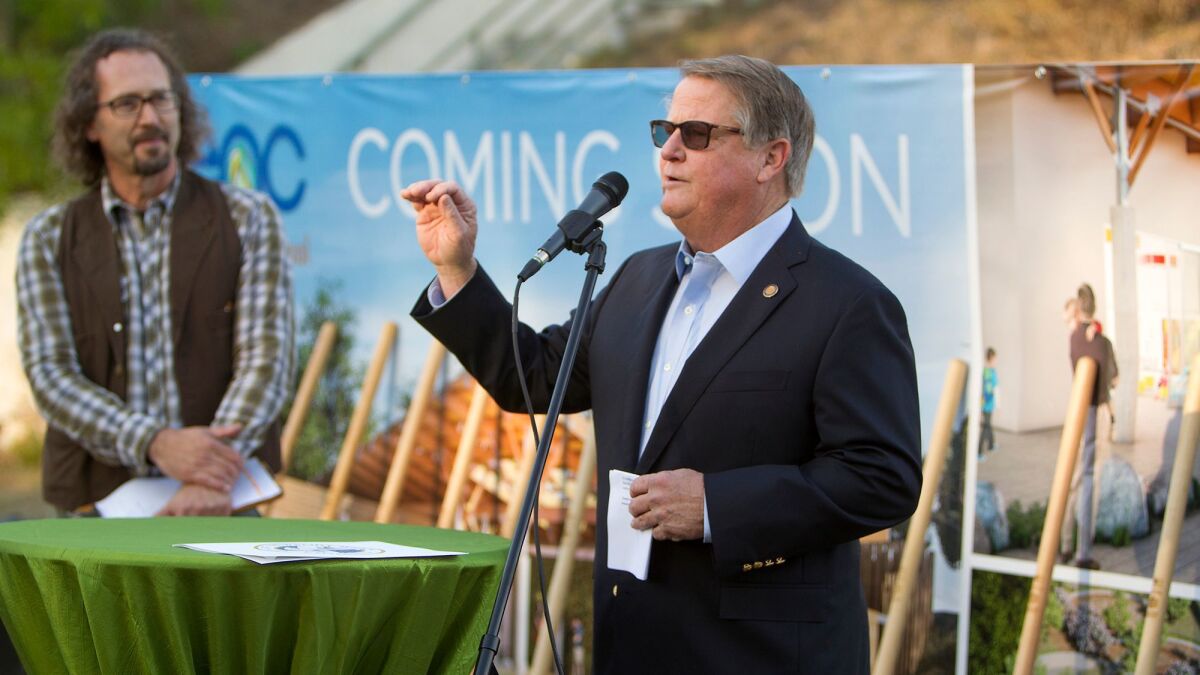 Newport Beach Mayor Mayor Marshall Duffield speaks during a groundbreaking ceremony Thursday for a three-classroom preschool at the Environmental Nature Center in Newport Beach. At left is Bo Glover, the nature center's executive director.
