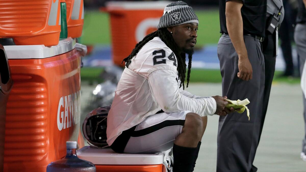 Oakland Raiders running back Marshawn Lynch sits during the national anthem prior to the team's exhibition game against the Arizona Cardinals on Aug. 12.