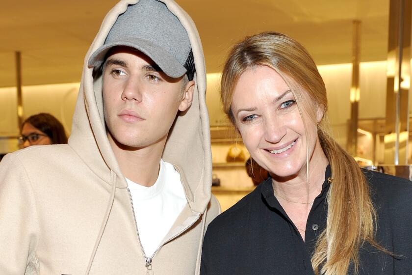 Singer Justin Bieber, left, with designer Anya Hindmarch at Barneys New York Beverly Hills on Oct. 15, 2015.