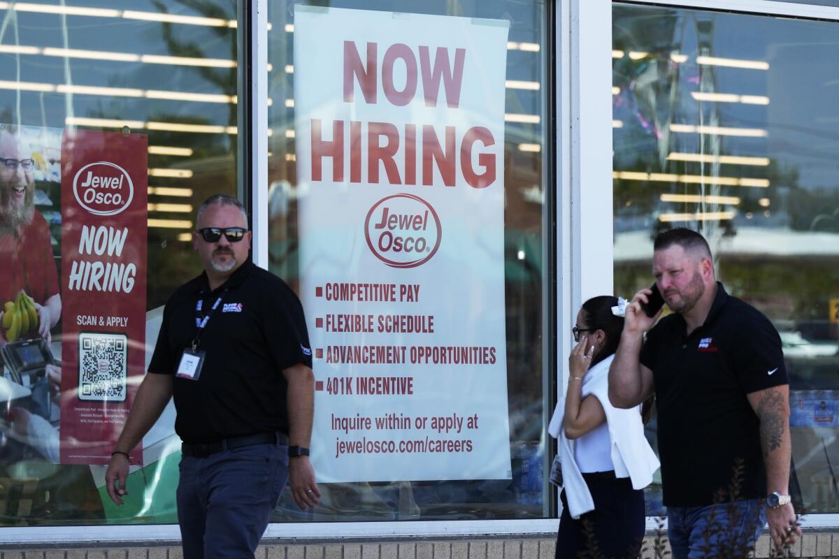 A hiring sign is displayed at a grocery store in Deerfield, Ill. 