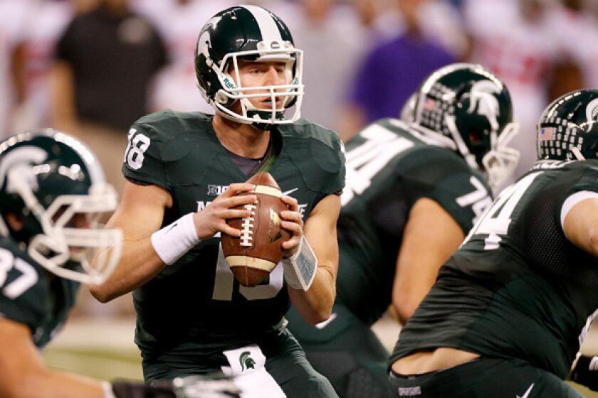 Michigan State quarterback Connor Cook drops back to pass against Ohio State in the Big Ten Conference championship game.
