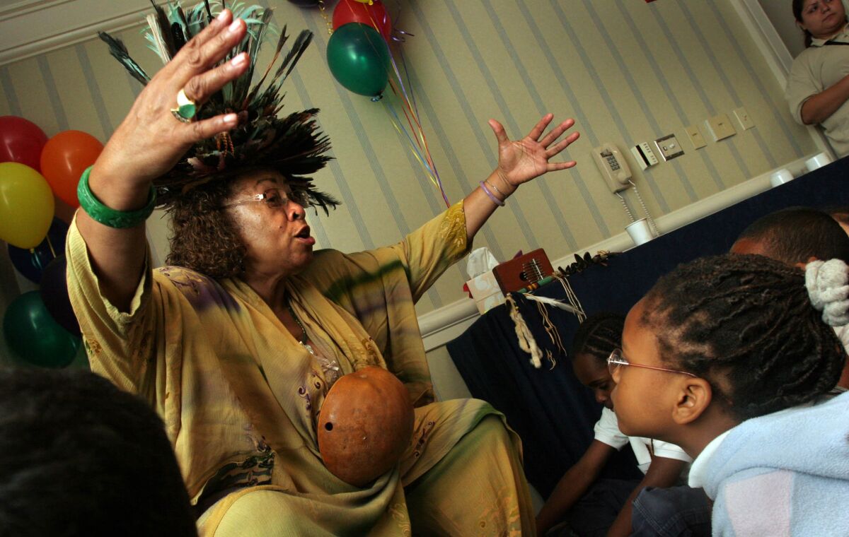 Alyce Smith Cooper in feathered "healing hat" regaled Johnson Elementary School students with stories in 2007.