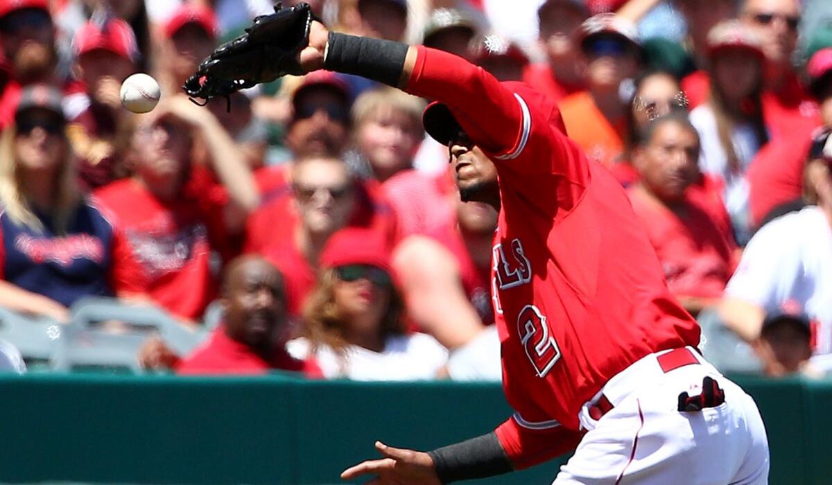 Angels shortstop Erick Aybar can't make the catch on a pop fly hit by the Rangers' Shin-Soo Choo in the second inning Sunday.