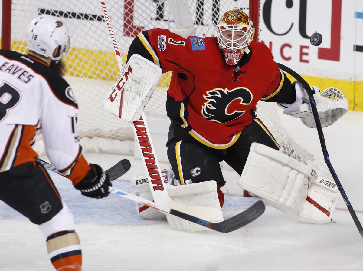 Calgary Flames goalie Brian Elliott, right, makes a save against Ducks forward Patrick Eaves during the first period Monday.