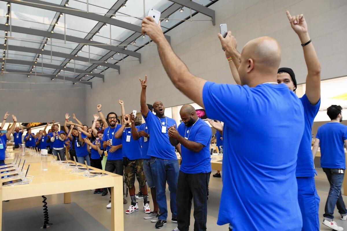 Apple sold 39.3 million iPhones in its fourth quarter. Above, employees at an Apple store in Santa Monica gear up for the start of iPhone 6 sales last month.
