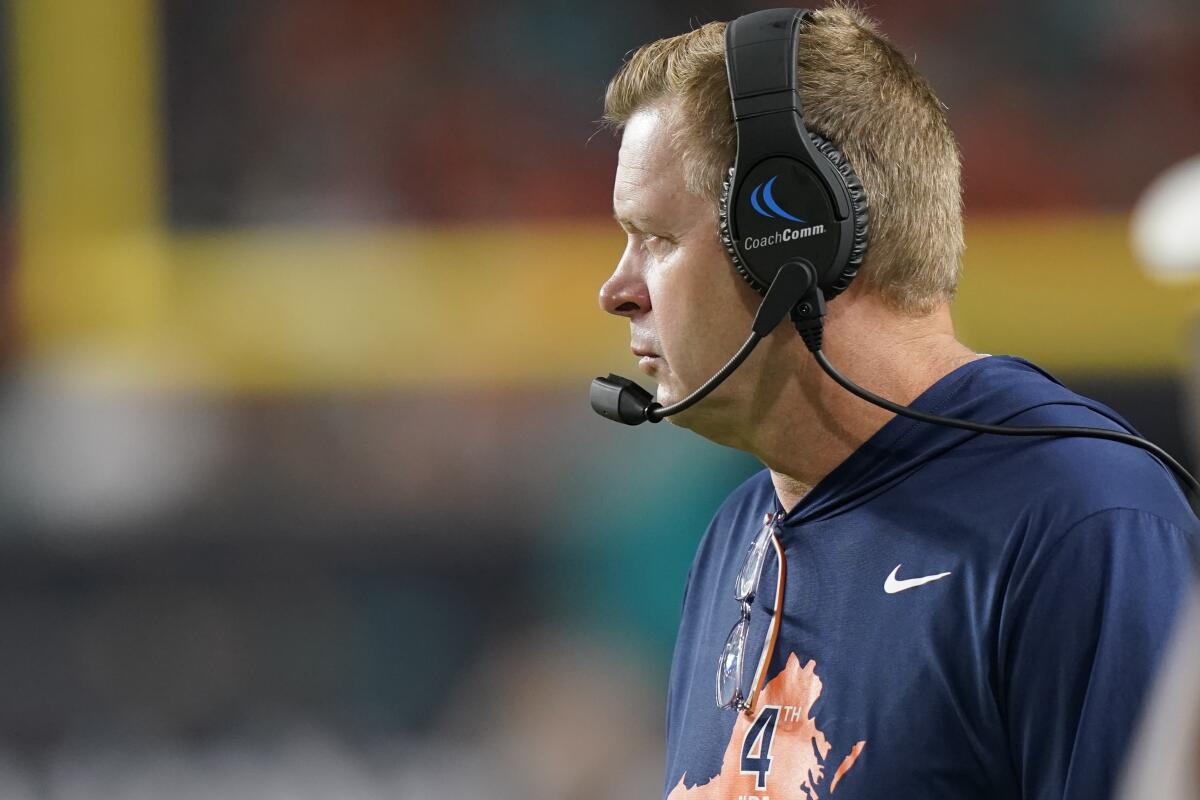 Virginia Cavaliers head coach Bronco Mendenhall watches the game from the sidelines during the second half of a NCAA college football game against Miami, Thursday, Sept. 30, 2021, in Miami Gardens, Fla. (AP Photo/Lynne Sladky)