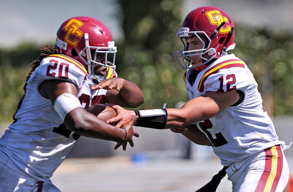Glendale College football QB #12 Nathan Eldridge hands off to #20 Adayus Robertson in game vs. West Los Angeles College, at the Wildcats Stadium in Culver City on Saturday, Sept. 29, 2018. GCC droppEd to 0-5 wiTh the 34-12 loss and WLAC is now 1-4.