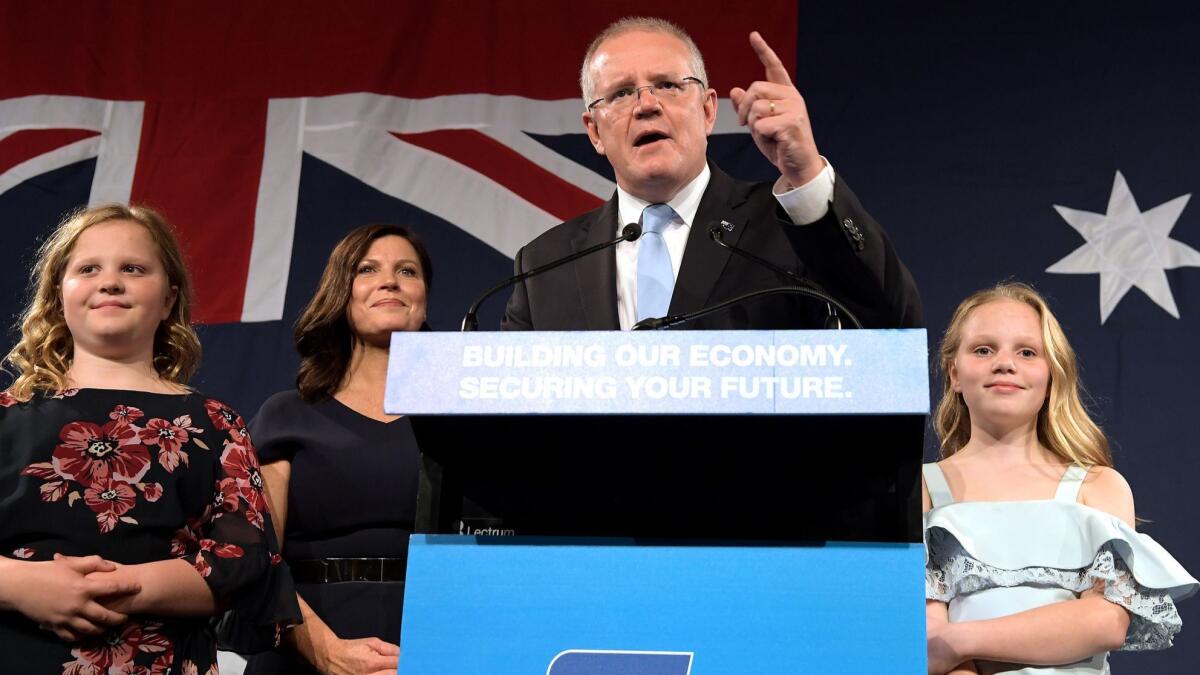 Prime Minister Scott Morrison of the Liberal Party, flanked by his wife, Jenny Morrison, and daughters Lily and Abbey, delivers his victory speech May 18 in Sydney.