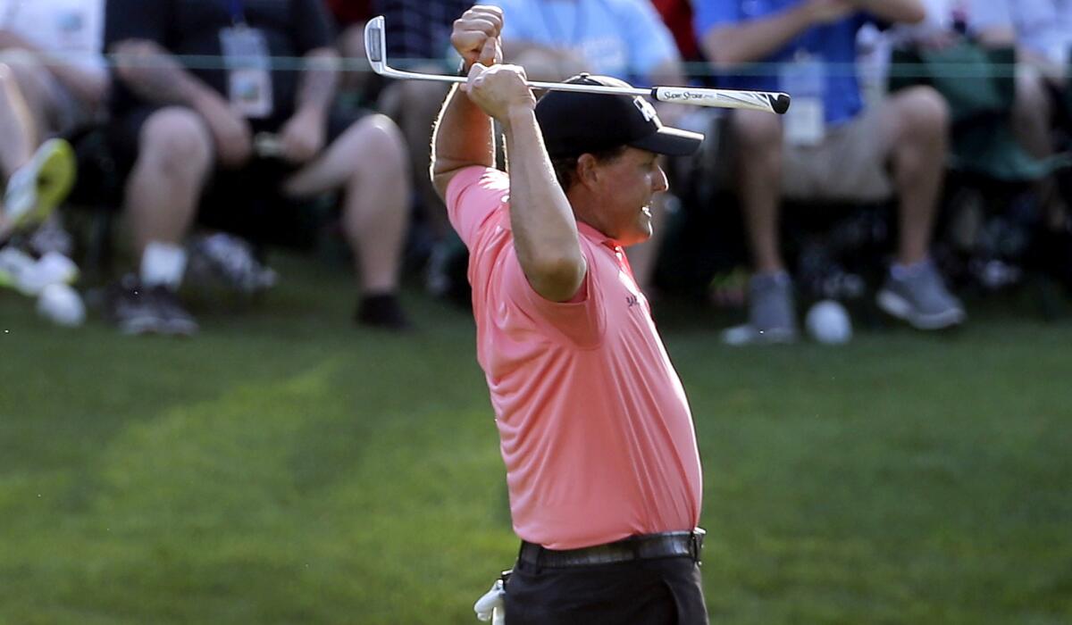 Phil Mickelson reacts after making a birdie putt at No. 16 on Saturday during the third round of the Masters.
