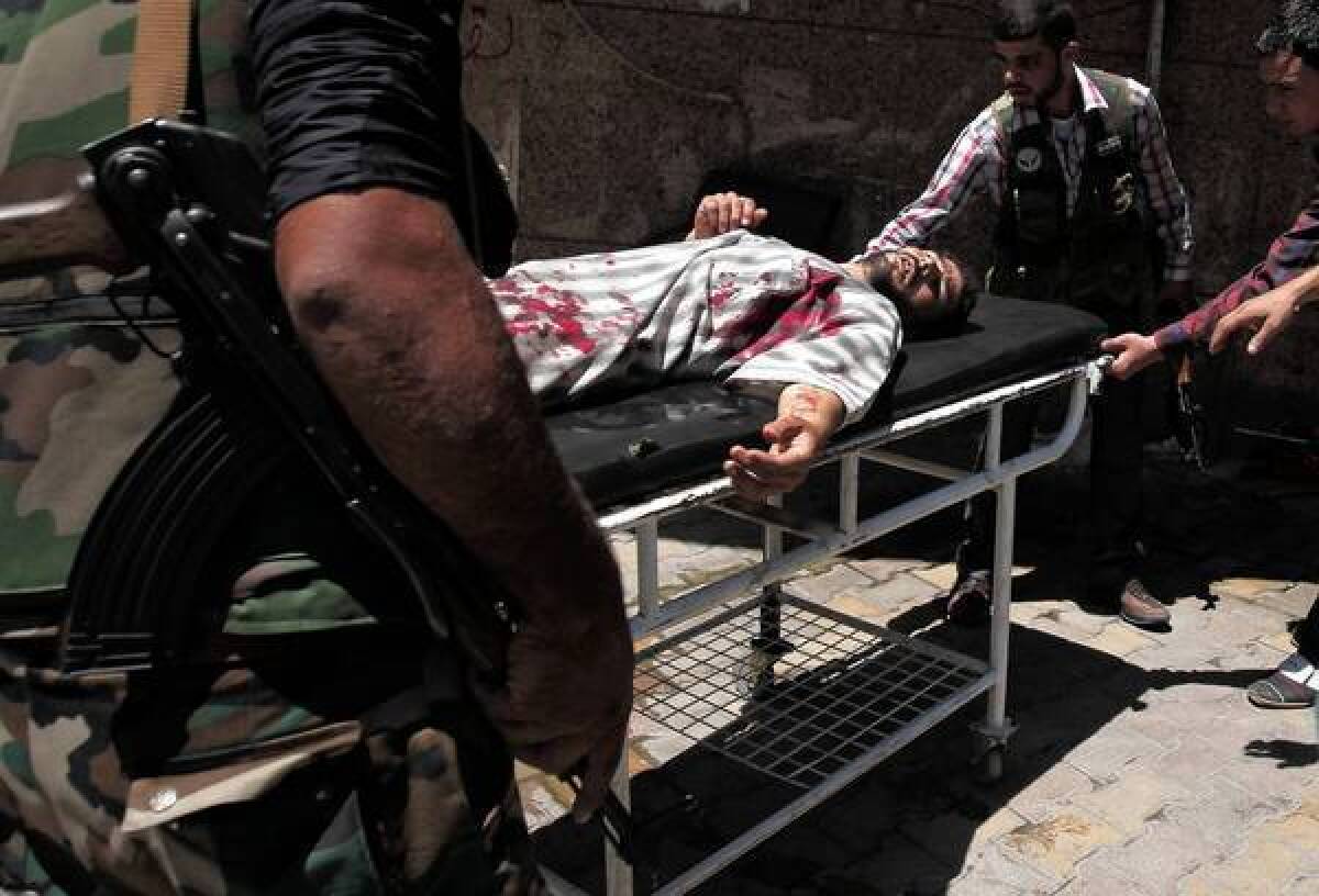 Syrian rebels in Aleppo rush a wounded man to a hospital.