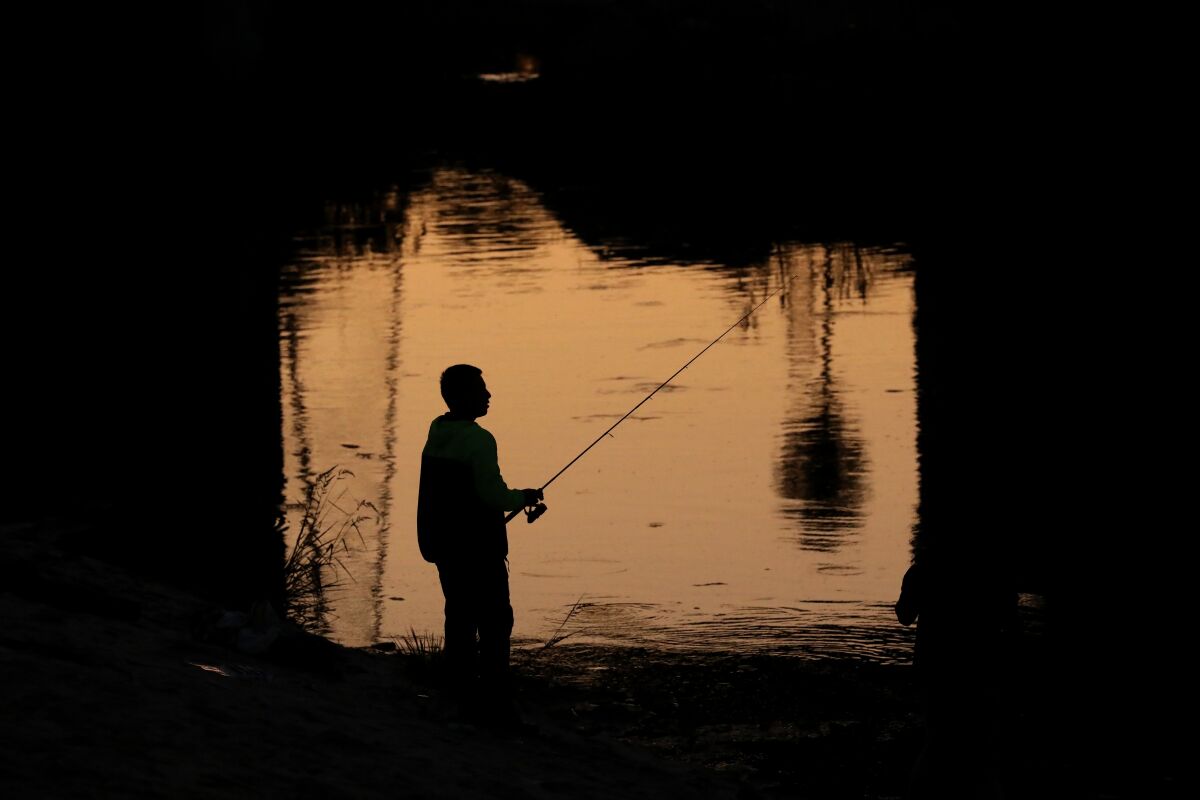Edgar Alvarez, 23, of Los Angeles, heads out frequently to fish along the Los Angeles River.