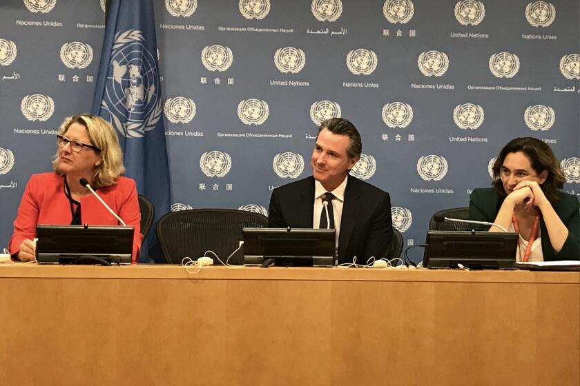 Gov. Gavin Newsom speaks at a press conference at the United Nations in New York with Svenja Schulze of Germany, left, and Barcelona Mayor Ada Colau, right, on Sept. 23, 2019.