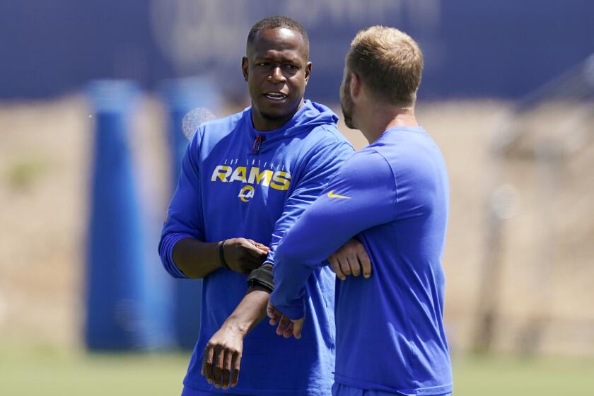 Los Angeles Rams defensive coordinator Raheem Morris, left, talks with head coach Sean McVay during an NFL football practice Friday, June 4, 2021, in Thousand Oaks, Calif. (AP Photo/Mark J. Terrill)