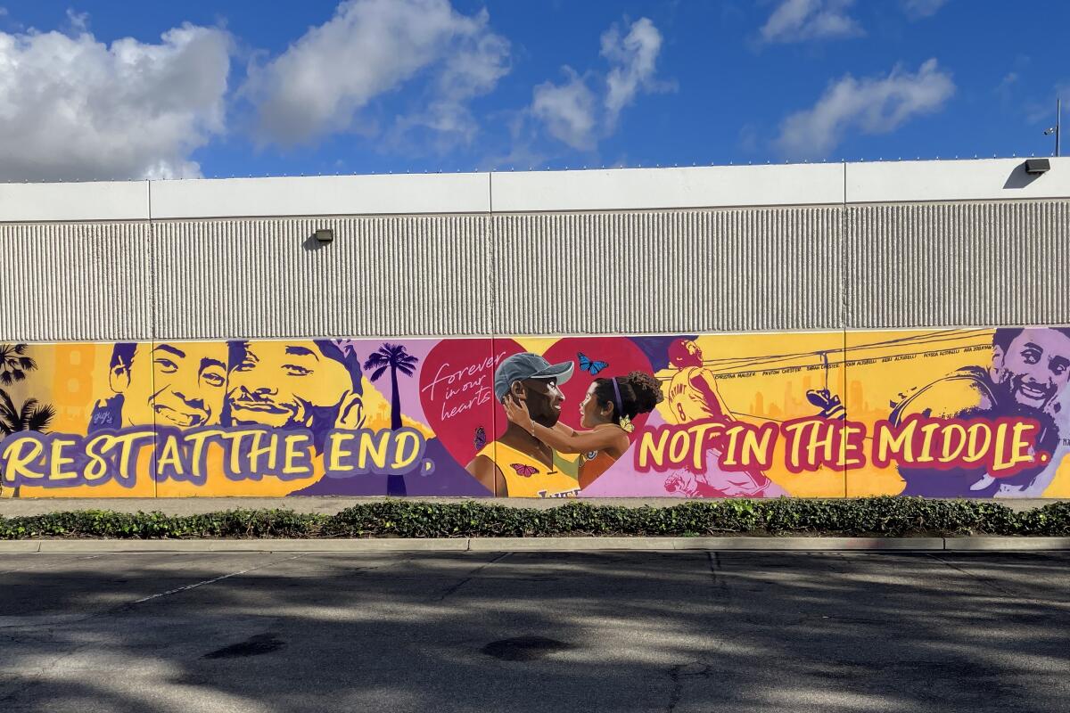 A mural outside ASHE Society in Santa Ana shows Kobe and Gianna Bryant hugging.