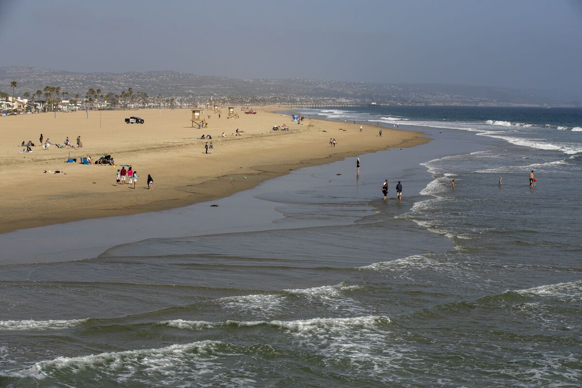 People enjoy a day at the beach near Newport Pier.