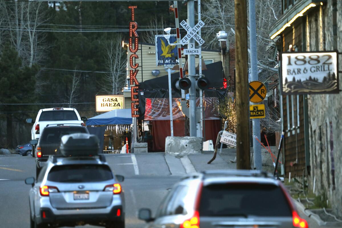 Motorist pass the historic sign looking up Bridge St. in downtown Truckee.