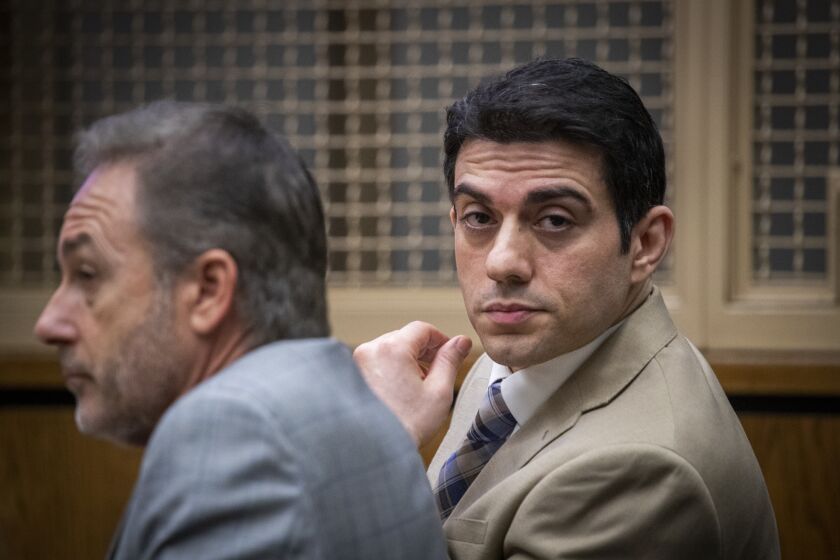 NEWPORT BEACH, CALIF. -- WEDNESDAY, JULY 17, 2019: Hossein Nayeri, right, seated next to his defense attorney Salvatore Ciulla, reacts as he listens to prosecuting attorney Heather Brown speak during opening statements at Newport Harbor Courthouse in Newport Beach Wednesday, July 17, 2019. Nayeri is accused of masterminding the plot to kidnap a pot-dispensary operator from his Newport Beach home in October 2012 and took him to the desert, where the man was sexually mutilated. Nayeri (in a separate trial) will also face charges of escaping from the Orange County jail. Nayeri?s supposed accomplice, Kyle Handley, was convicted of playing a role in the kidnapping. Photo taken in Newport Beach, Calif., on July 17, 2019. (Allen J. Schaben / Los Angeles Times)