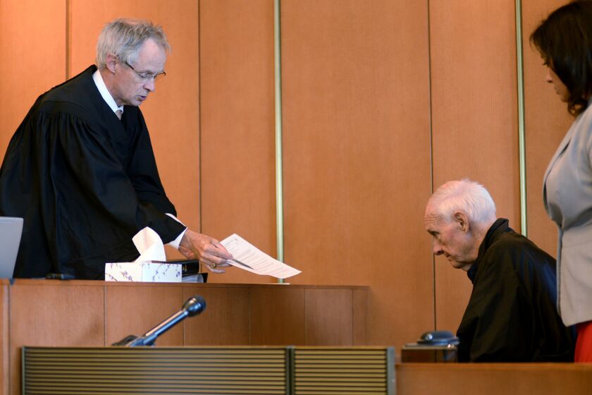 FILE - In this Monday, Aug. 10, 2015 file photo, Judge Timothy Feeley, left, addresses former the Rev. Richard J. McCormick, 74, in Salem Superior Court in Boston. Joey Covino said the entirety of his adult life had been altered by McCormick’s abuse over two summers at a Salesian camp - failed relationships, his decisions to join the military and later the police, nightmares that plagued him. His decision to come forward led to McCormick being convicted of rape in 2014 and sentenced to up to 10 years. McCormick since has pleaded guilty to assaulting another boy. (Faith Ninivaggi/The Boston Herald via AP, Pool)