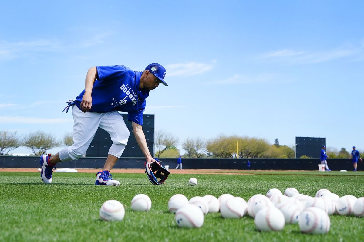 Dodgers right fielder Mookie Betts warms up during a spring training workout on March 13.