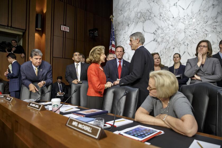 Members of the Senate Armed Services Committee gather to hear Defense Secretary Chuck Hagel and Army Gen. Martin Dempsey testify on President Obama's strategy to combat Islamic State extremists.