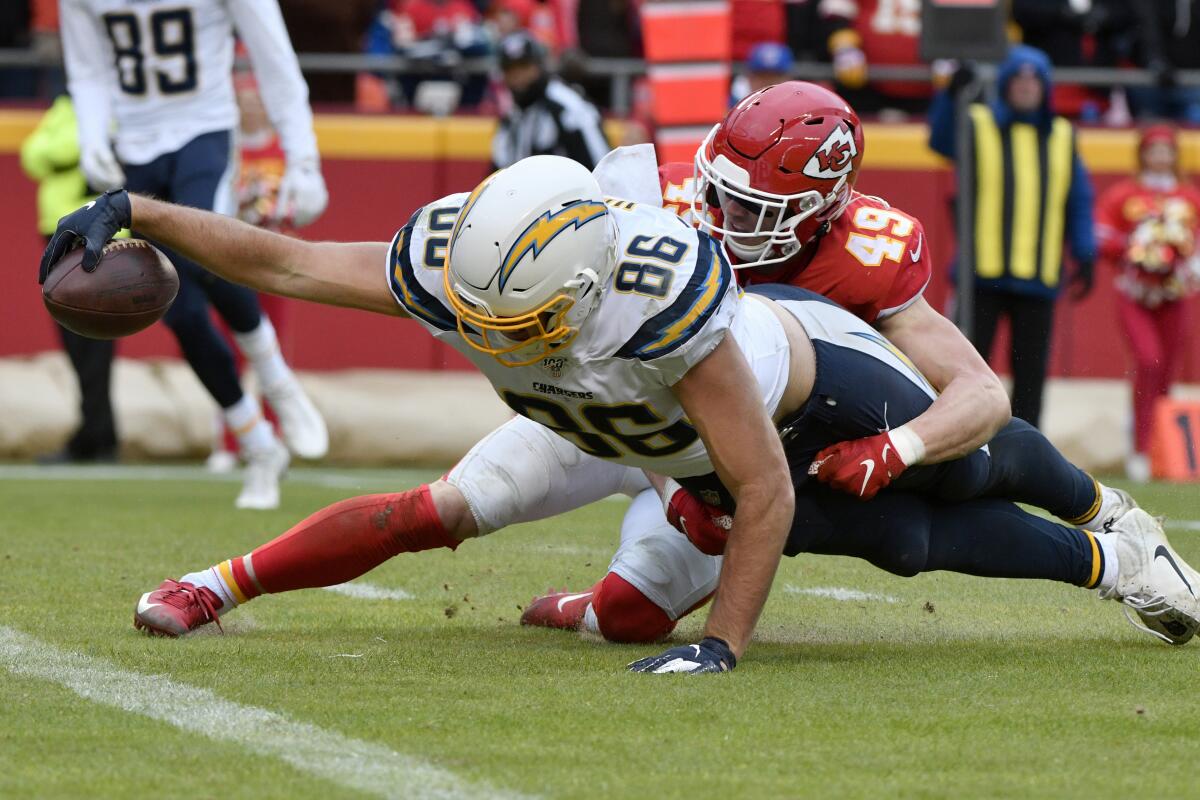 Los Angeles Chargers tight end Hunter Henry (86) extends his reach for a touchdown against Kansas City Chiefs safety Daniel Sorensen (49) during the second half of an NFL football game in Kansas City, Mo., Sunday, Dec. 29, 2019. (AP Photo/Ed Zurga)