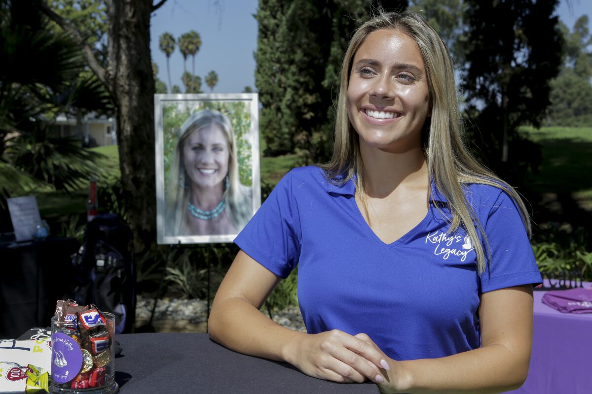 Madison Scharbarth, 22, stands with a photograph of her mother, Kathy Scharbarth taken in 2011.