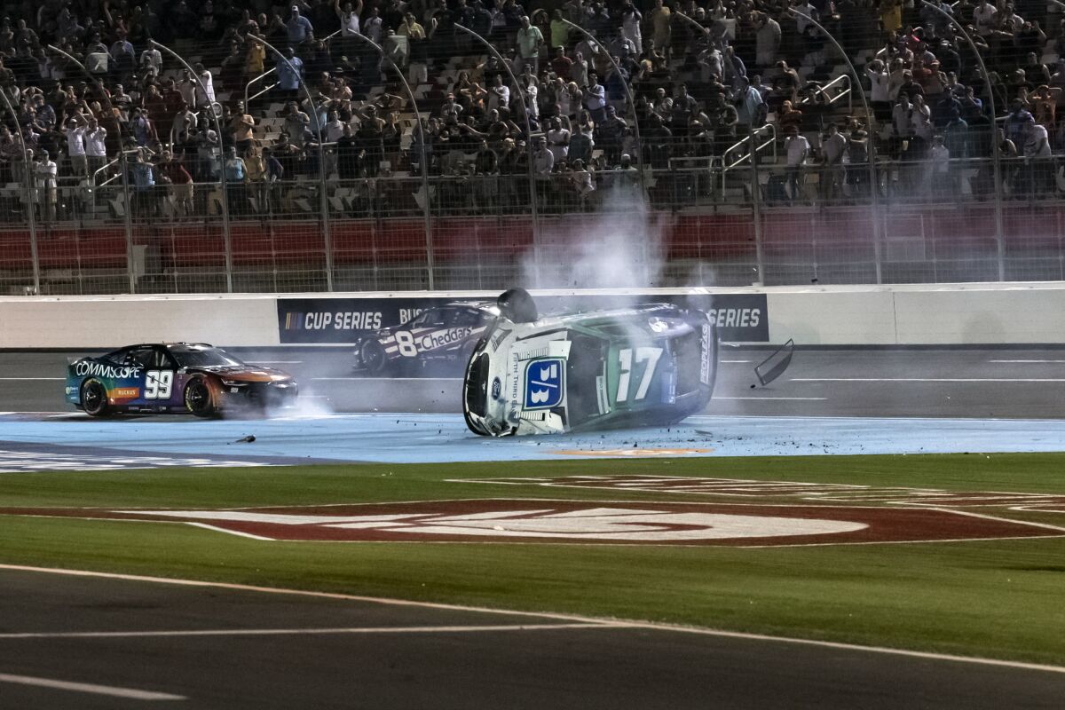 Chris Buescher (17) and Daniel Suarez (99) crash during a NASCAR Cup Series auto race at Charlotte Motor Speedway, Sunday, May 29, 2022, in Concord, N.C. (AP Photo/Matt Kelley)