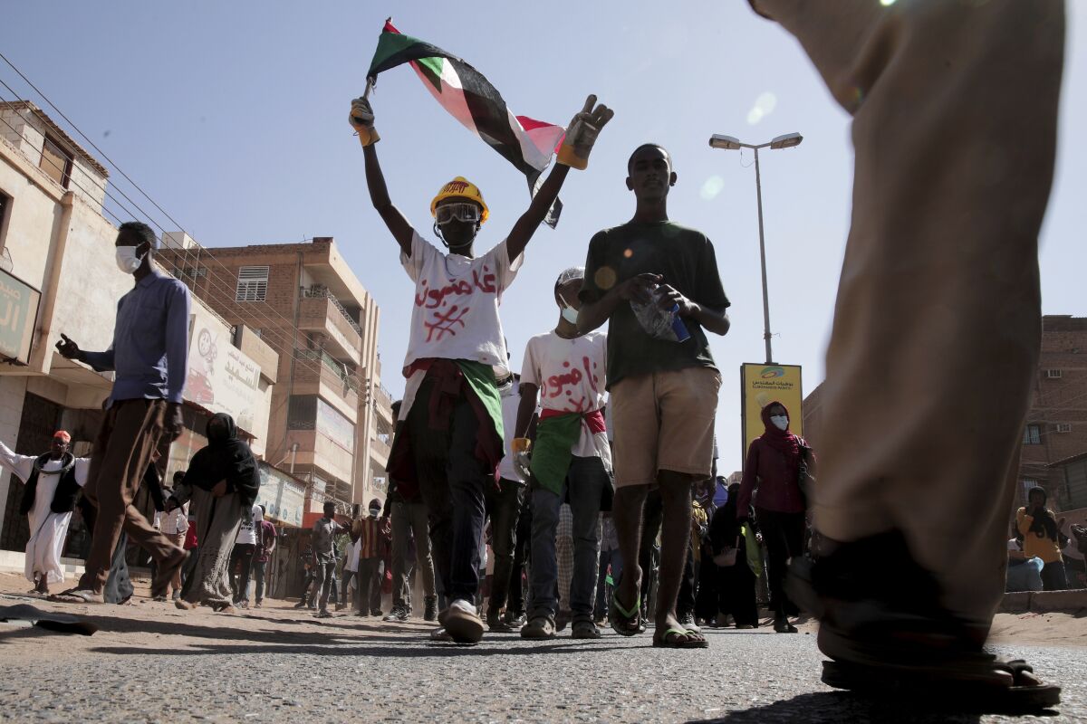 People chant slogans during a protest to denounce the October 2021 military coup, in Khartoum, Sudan, Thursday, Jan. 6, 2022. Sudanese took to the streets in the capital, Khartoum, and other cities on Thursday in anti-coup protests as the country plunged further into turmoil following the resignation of the prime minister earlier this week. (AP Photo/Marwan Ali)