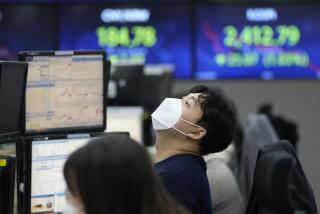 A currency trader stretches at the foreign exchange dealing room of the KEB Hana Bank headquarters in Seoul, South Korea, Monday, Nov. 28, 2022. Shares skidded in Asia on Monday, with Hong Kong briefly dipping more than 4% following weekend protests in various cities over China’s strict zero-COVID lockdowns. (AP Photo/Ahn Young-joon)