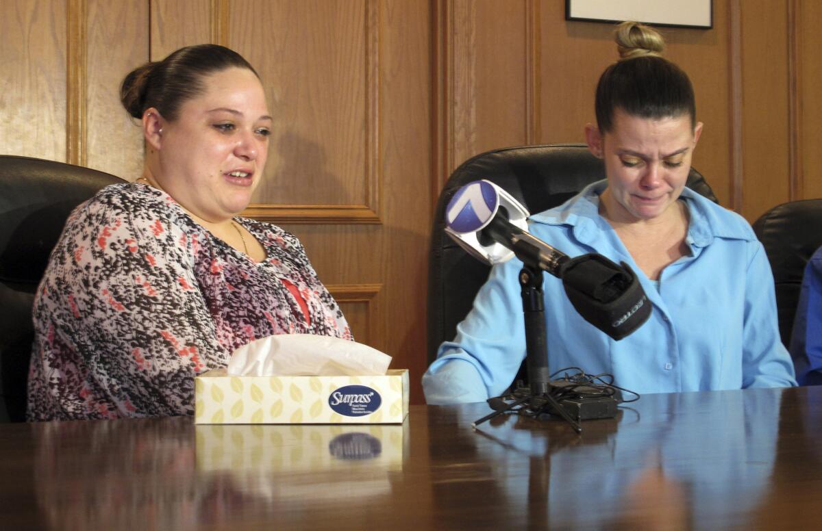 Amber McGuire, left, recounts the execution of her father, Dennis McGuire, as her sister-in-law Missie McGuire cries at a news conference on Friday when they announced a planned lawsuit against the state over the unusually slow execution.
